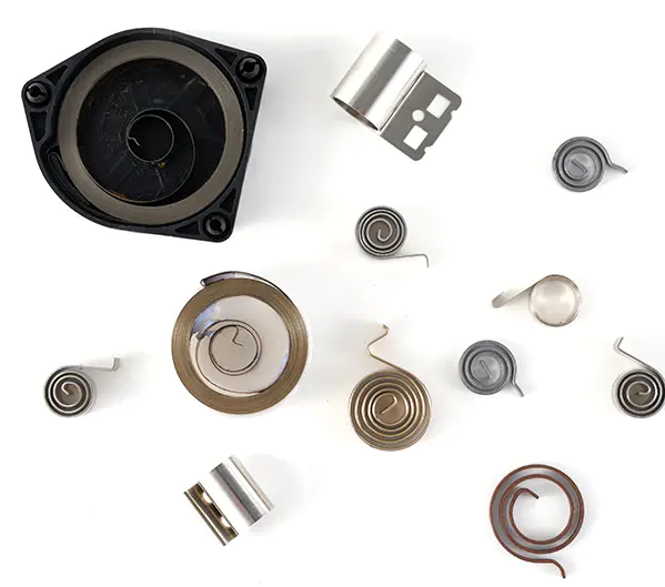 Assortment of custom torsion springs, constant force springs, and power springs in various metals and finishes – NDLSpr precision components
